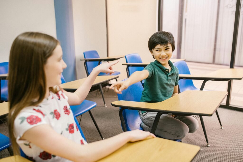 pexels-photo-6936385-6936385 Children interacting and smiling in an educational classroom environment.