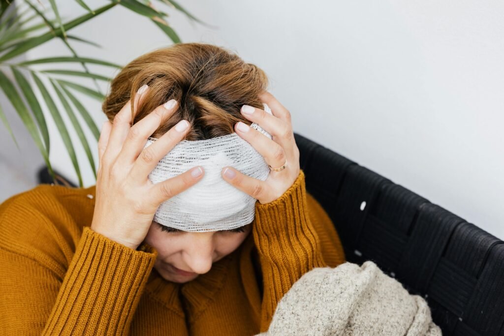 pexels-photo-5207232-5207232 Woman with head injury holding her head in pain indoors.